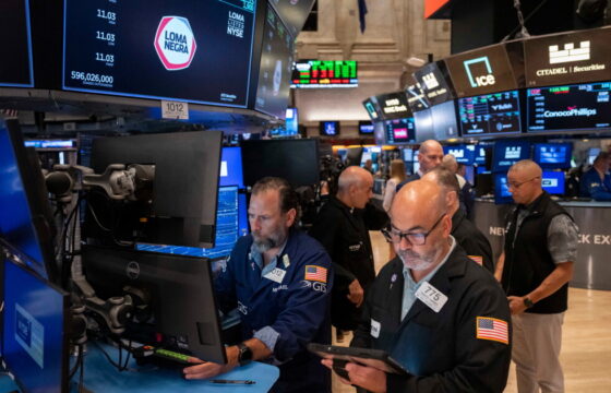 Traders work on the floor as markets assess July inflation and Federal Reserve policy
