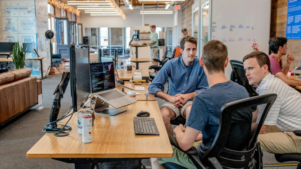 Business team discussing data on a laptop in an office