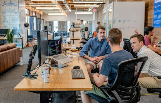 Business team discussing data on a laptop in an office
