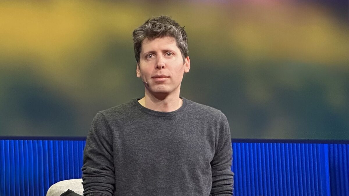 Sam Altman speaking on stage at TED