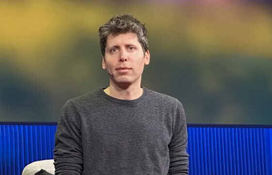 Sam Altman speaking on stage at TED